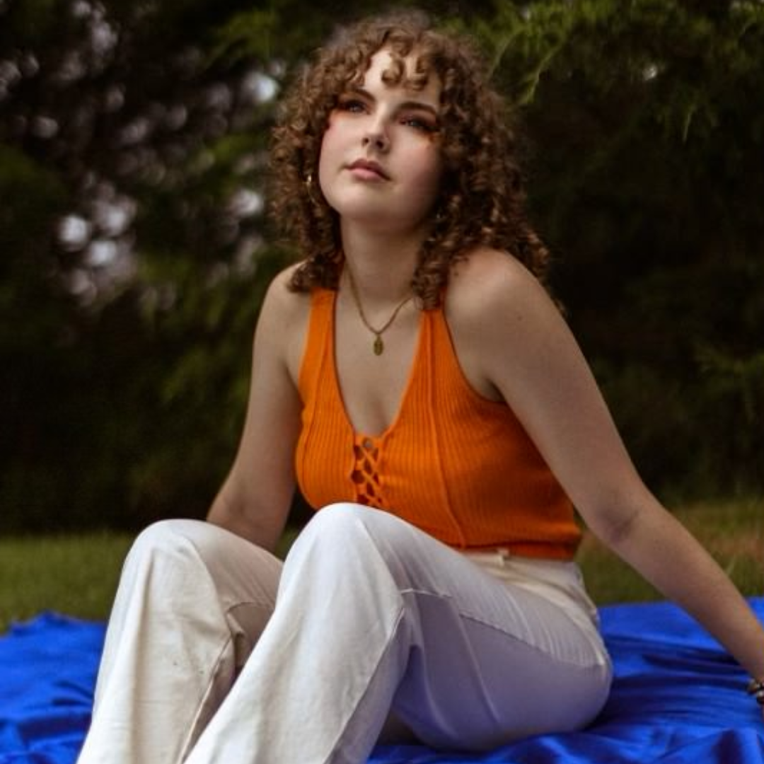 sofia young on a blanket in the grass
