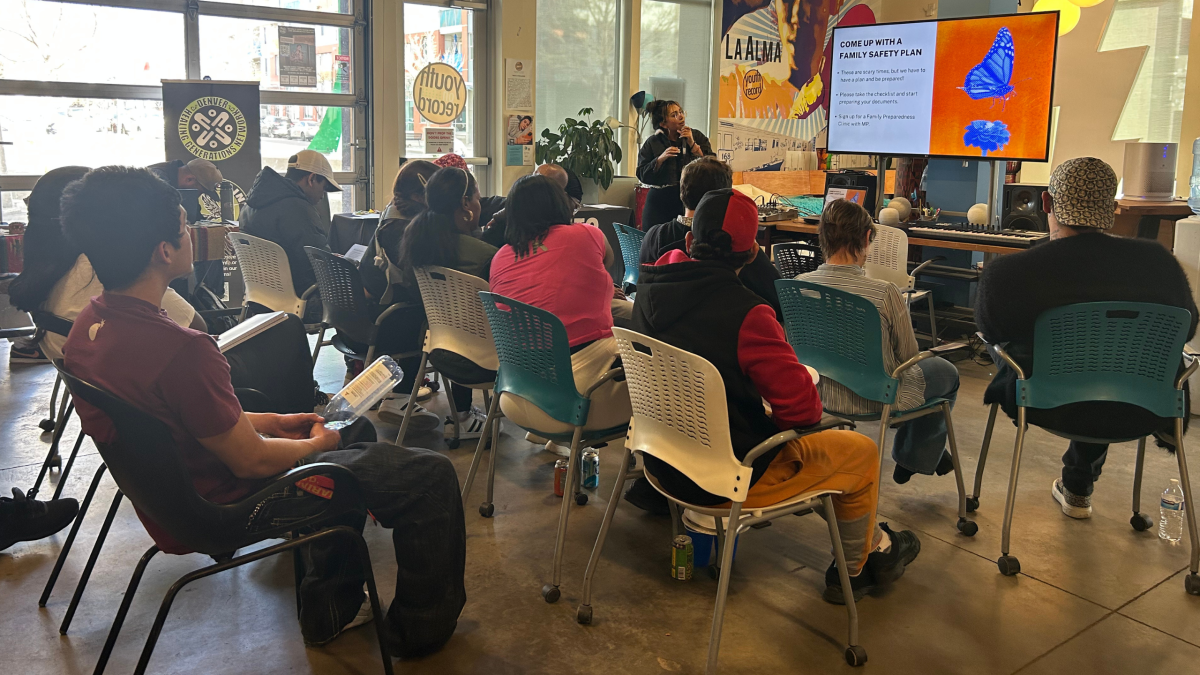 a group of community members attending an open house at the youth media studio