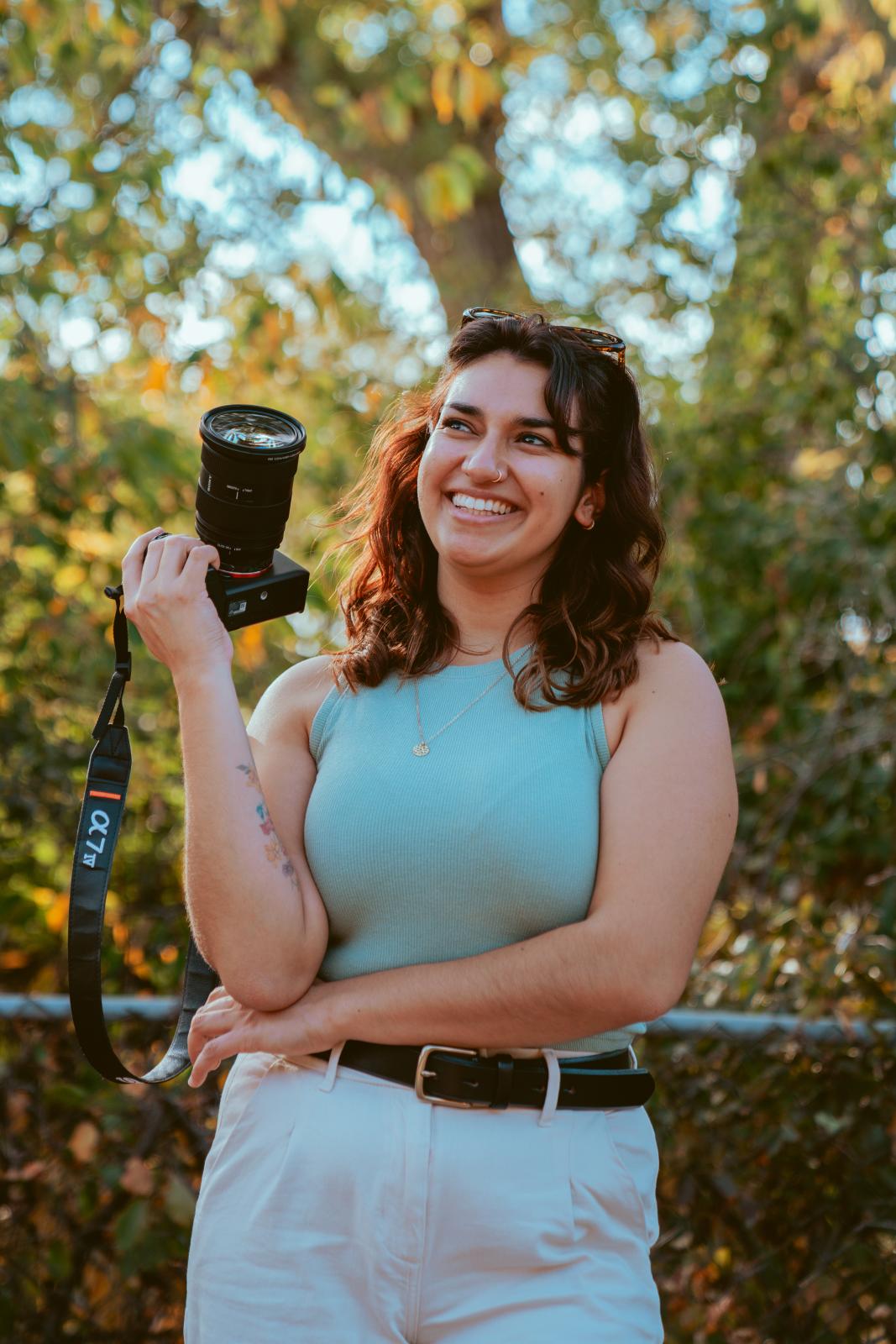 Sydney Yllanes holds a camera