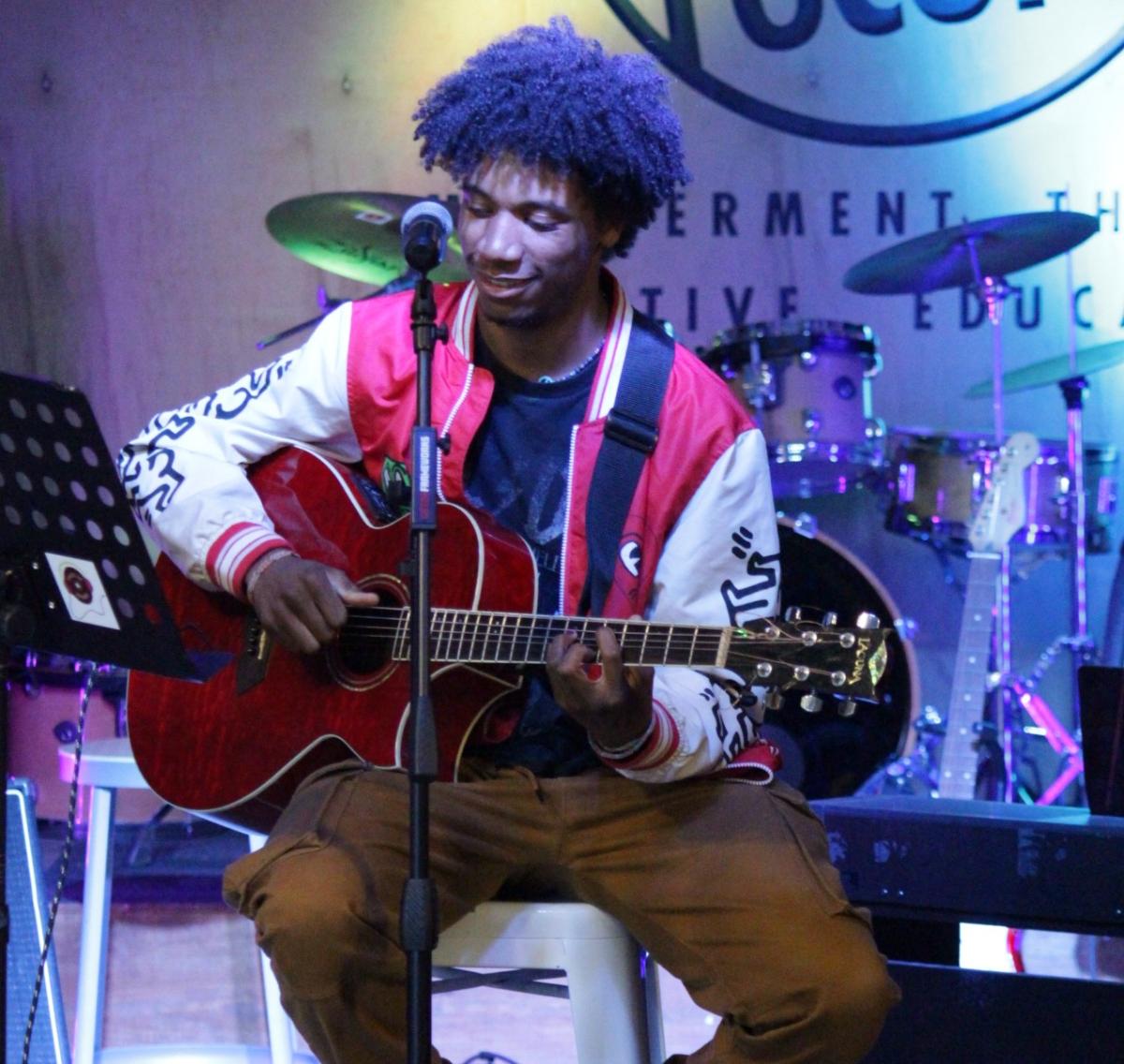 Gabe plays guitar at Youth on Record