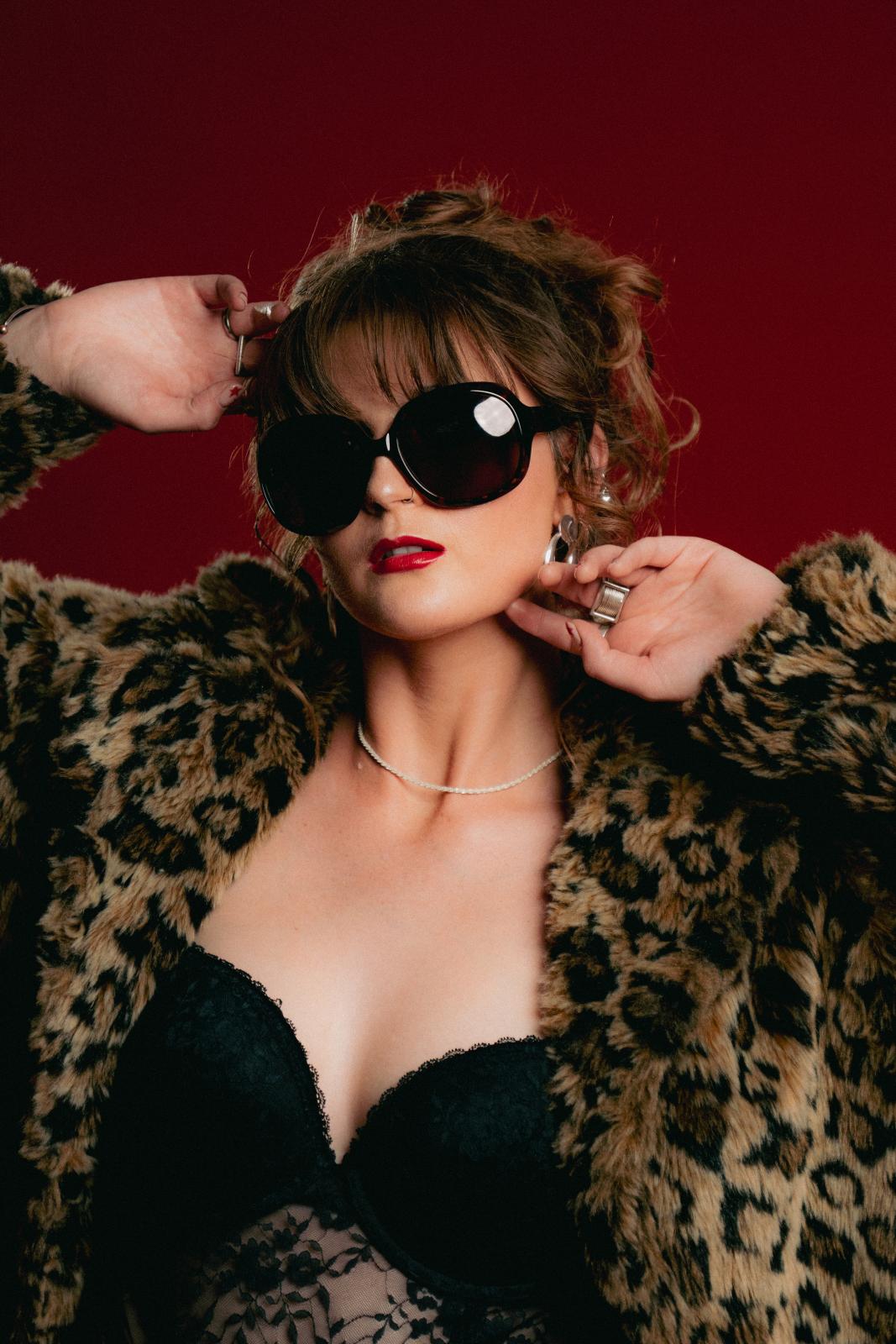 Audrey wearing sunglasses and a coat