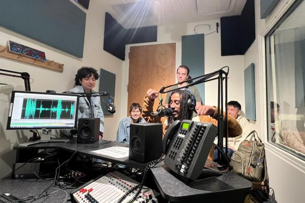 Podcast interns record audio in a podcast studio