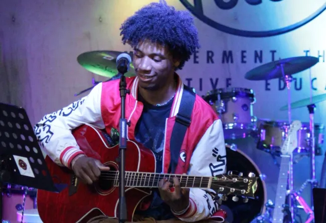 Gabe plays guitar at open mic